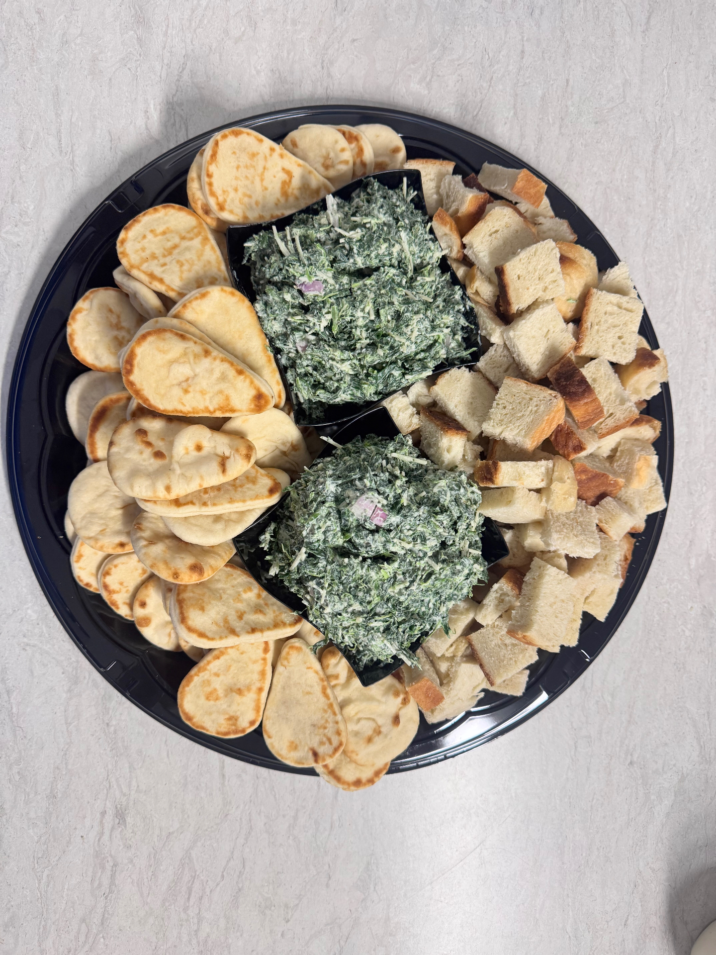 Spinach dip with green olives, sourdough bites, cheese, and meat