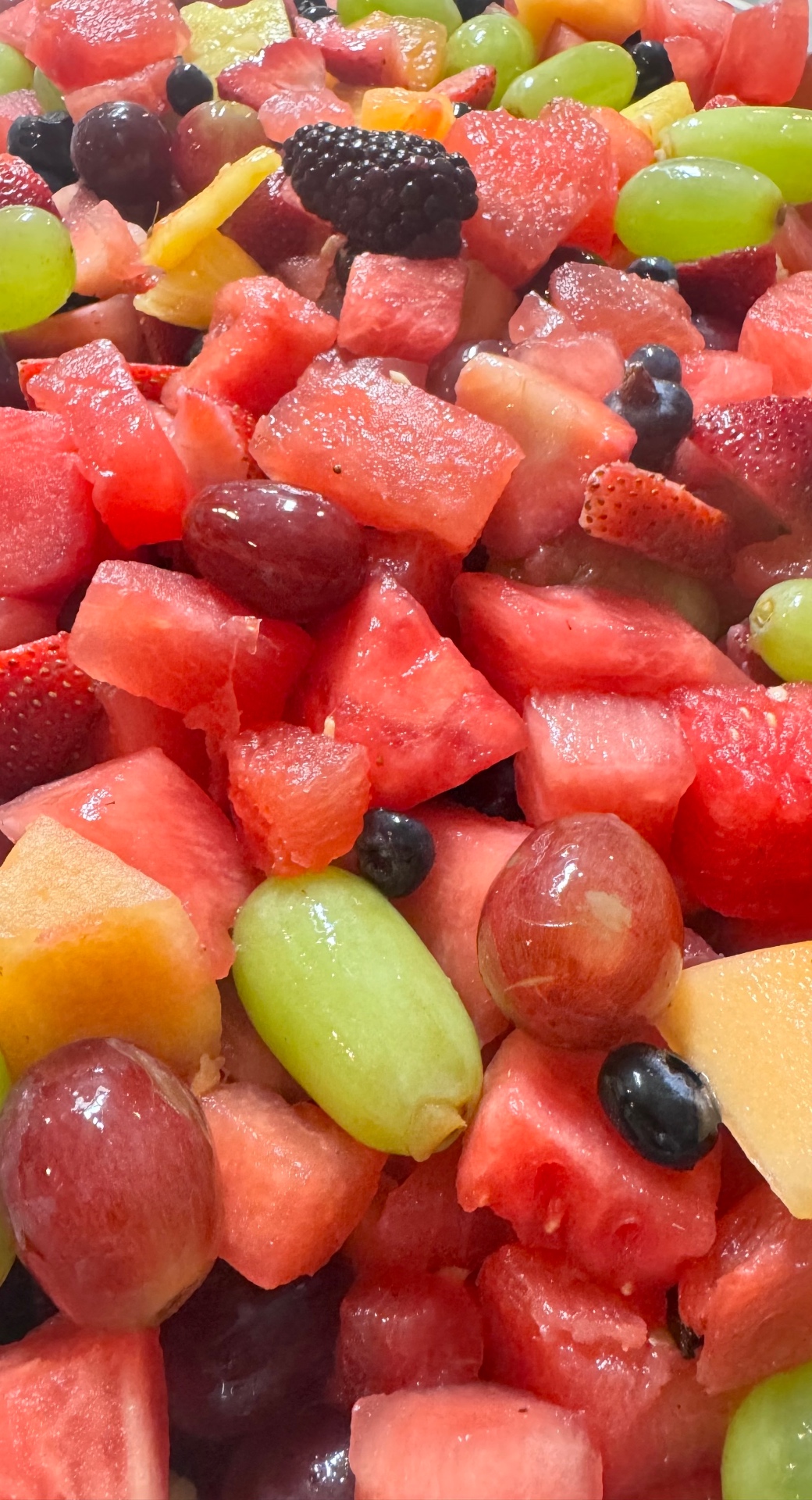 Fresh fruit salad with watermelon, grapes, and berries